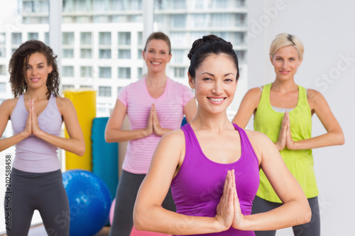 Women with hands joined exercising at gym © WavebreakmediaMicro