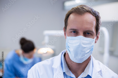 Dentist wearing surgical mask in dental clinic