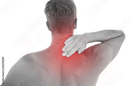 Muscled man having a neck ache on white background