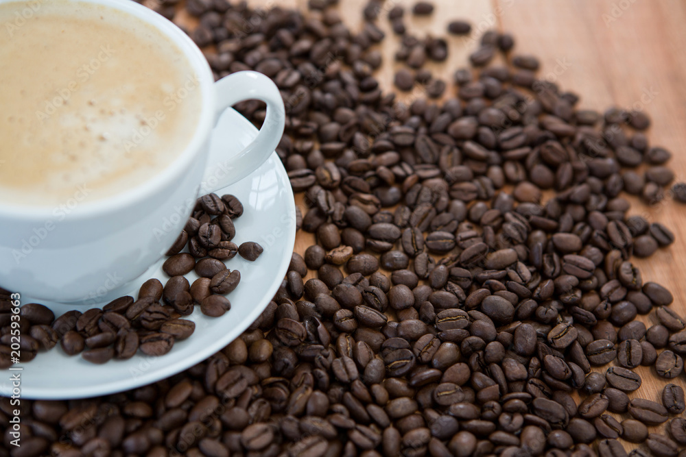 Fototapeta premium Cup of coffee with roasted coffee beans