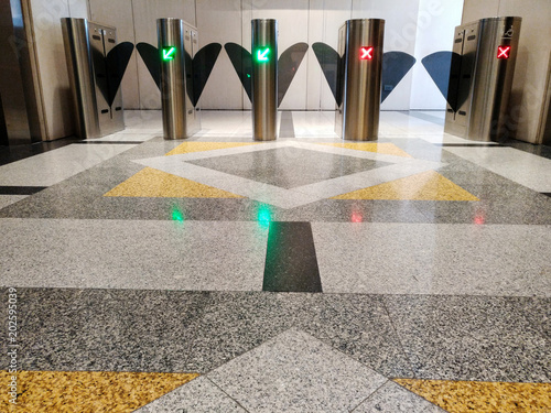 automatic gate using key card for screening outside people from blending in. green color to get through, red not to pass, security checking concept