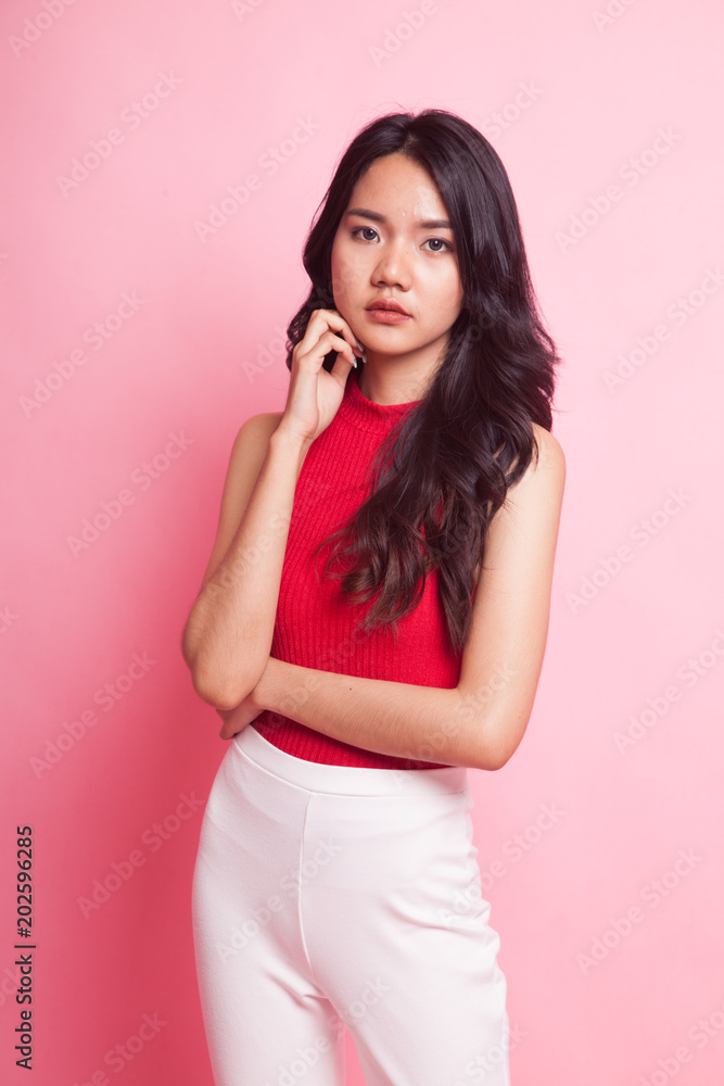Fototapeta premium Portrait of beautiful young Asian woman in red shirt.