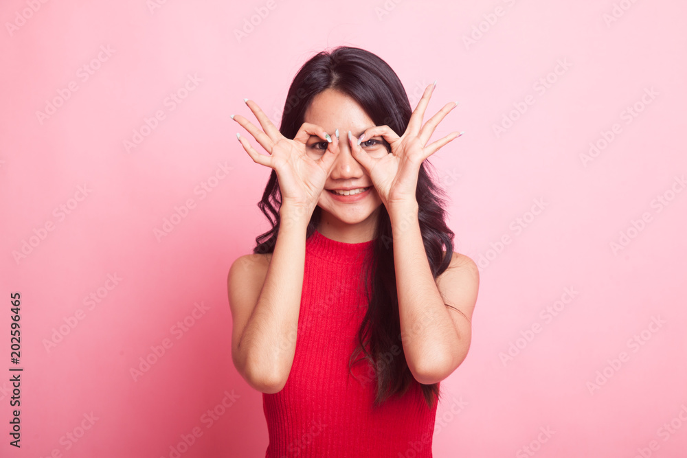 Asian woman do funny double OK sign as glasses. Asian woman do funny double OK sign as glasses.