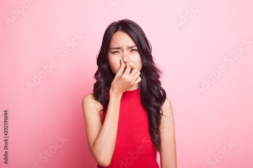 Fotografie Young Asian woman  holding her nose because of a bad smell.