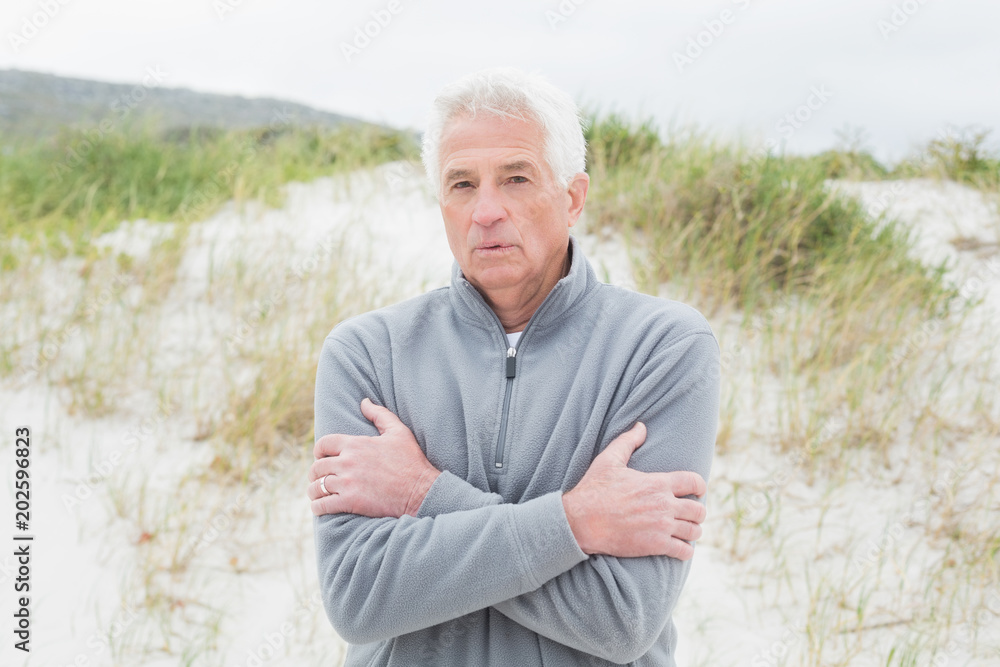 Casual senior man feeling cold at beach Casual senior man feeling cold at beach