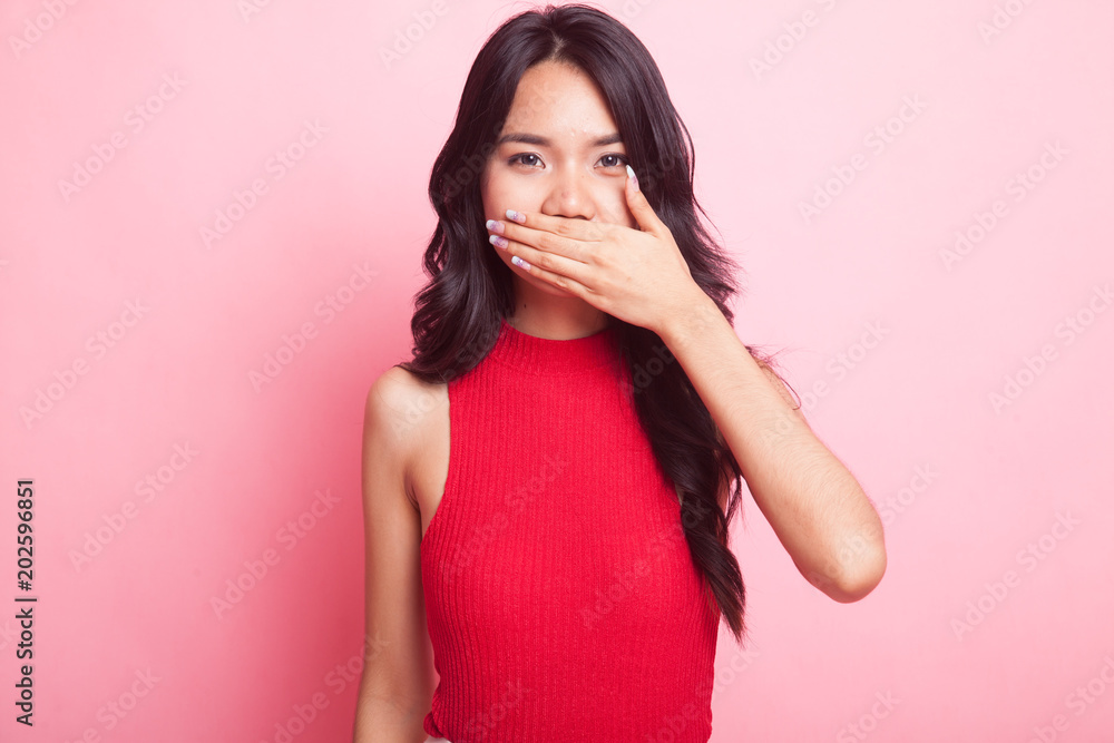 Young Asian woman close her mouth with hand. Young Asian woman close her mouth with hand.
