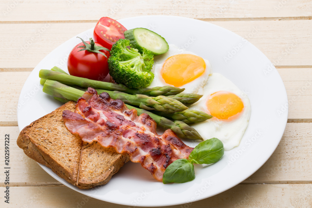 Fried eggs with bacon on the wooden table. Fried eggs with bacon on the wooden table.