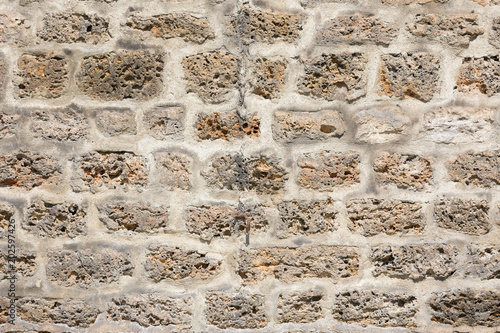 background of ancient wall built of white stone , texture