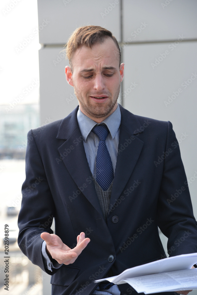 businessman emotionally reading documents businessman emotionally reading documents