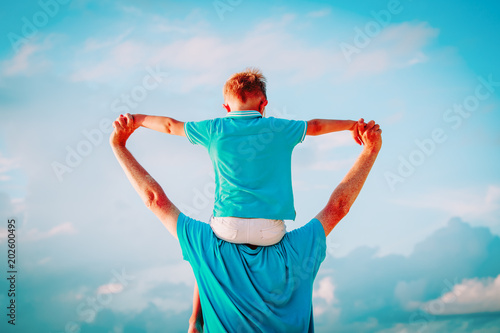 Tableau sur toile father and son having fun on sky
