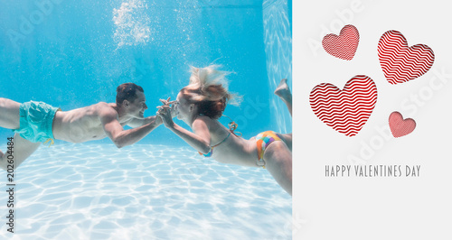 Billede på lærred Cute couple kissing underwater in the swimming pool against cute valentines mess