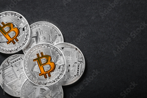 bitcoins coins on a black background. bitcoin is the most popular cryptocurrency in the world. photo