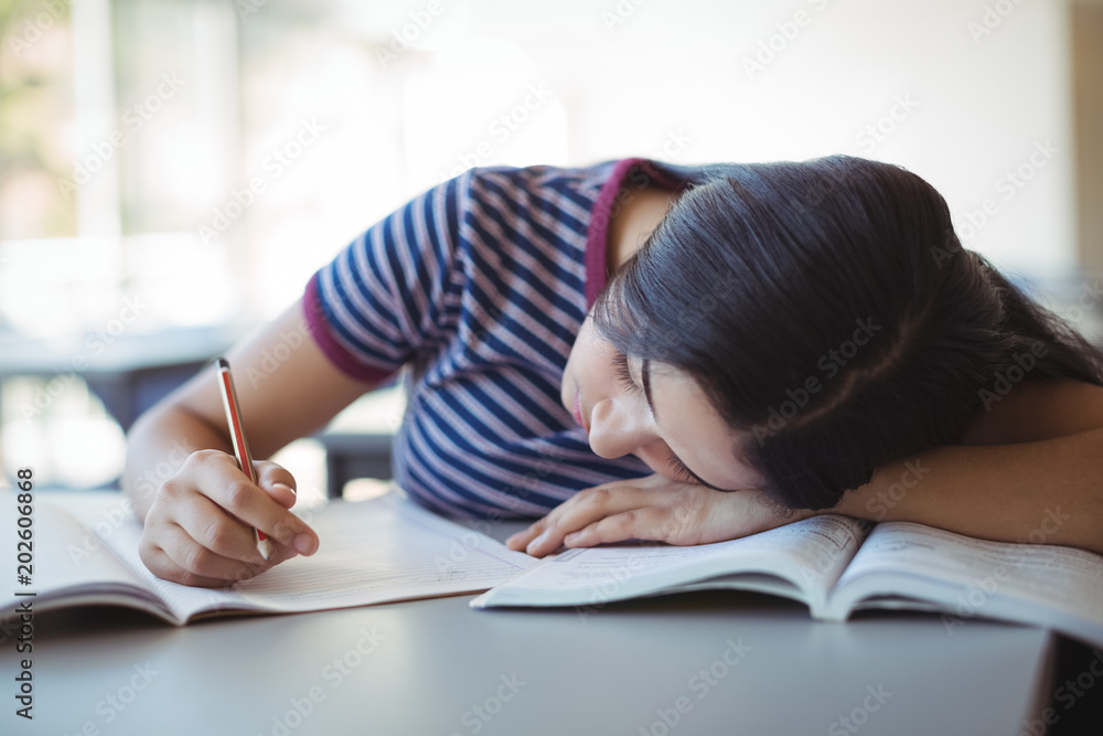Tired schoolgirl sleeping in classroom Tired schoolgirl sleeping in classroom