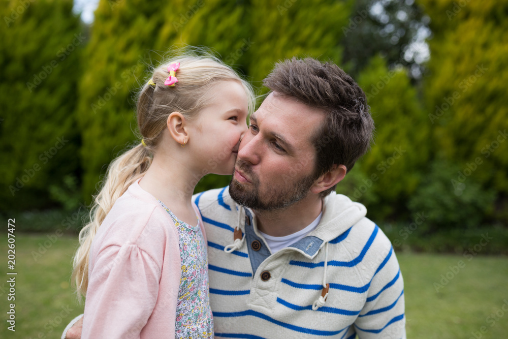 Young girl kissing her father Young girl kissing her father