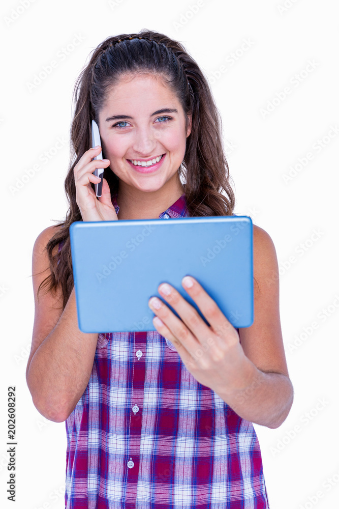 Happy pretty brunette using tablet computer and having phone call Happy pretty brunette using tablet computer and having phone call