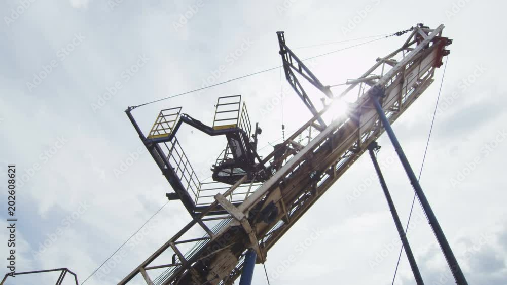 Courageous Employee Works on Geodetic Machine Top