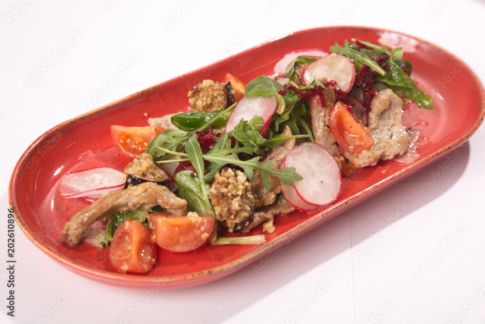 Salad with radish on red plate Salad with radish on red plate