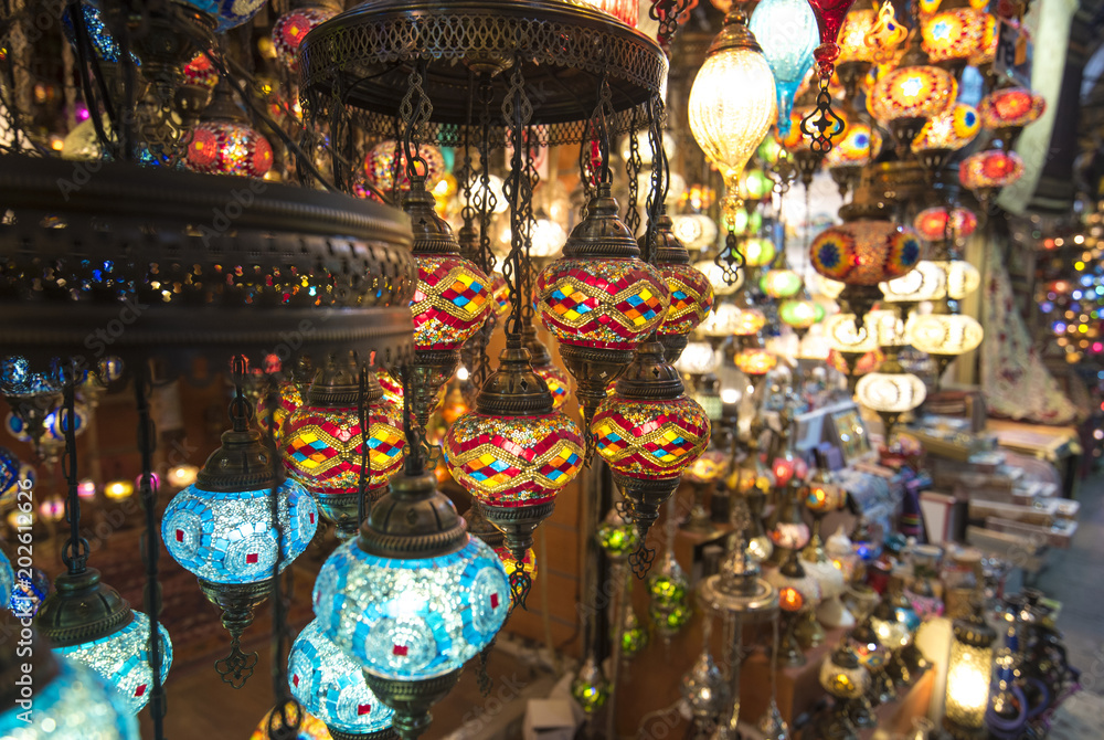 Amazing traditional handmade turkish lamps in souvenir shop. Mosaic of colored glass. Lit in the evening, creating a cozy atmosphere. lamps for sale on Grand Bazaar (kapali carsi) at Istanbul, Turkey
