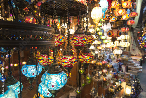 Amazing traditional handmade turkish lamps in souvenir shop. Mosaic of colored glass. Lit in the evening, creating a cozy atmosphere. lamps for sale on Grand Bazaar (kapali carsi) at Istanbul, Turkey photo