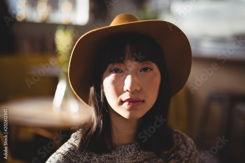 Portrait of young woman wearing hat