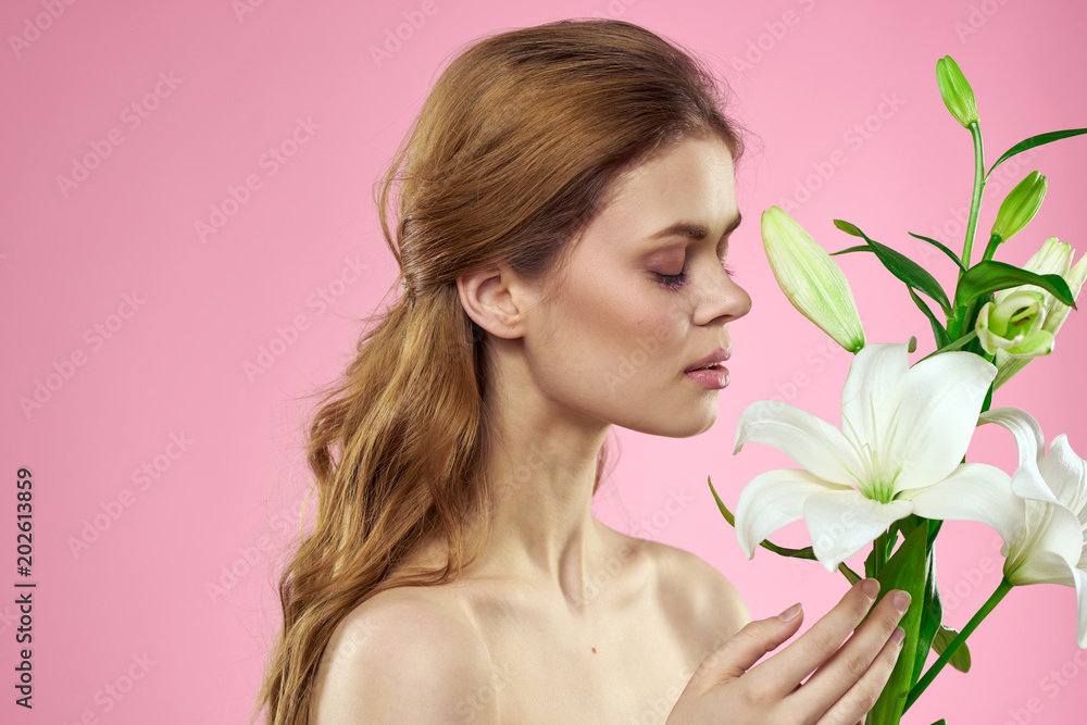 woman with flowers on a pink background