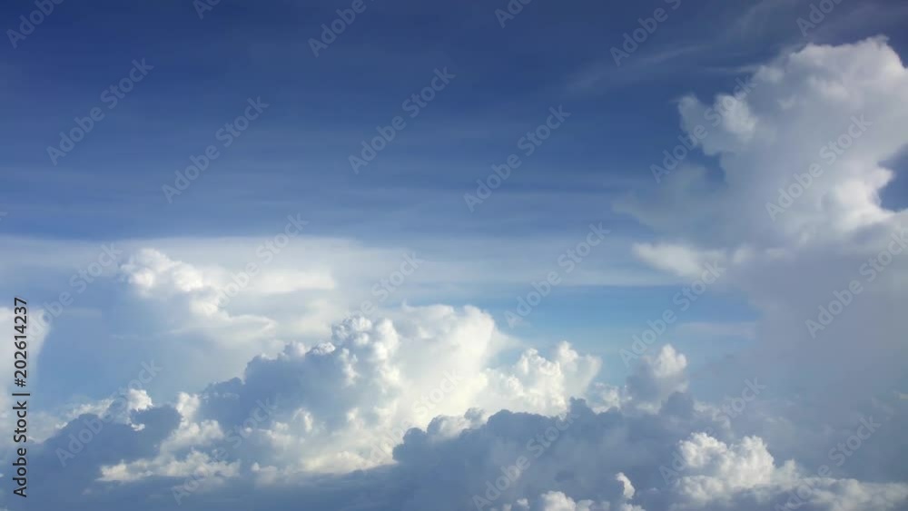 4K Traveling by air. Wonderful view of the sky and clouds from above, as seen through an airplane window. Plane in flight trip and beautiful views from the perspective of the traveler in the cabin-Dan 4K Traveling by air. Wonderful view of the sky and clouds from above, as seen through an airplane window. Plane in flight trip and beautiful views from the perspective of the traveler in the cabin-Dan