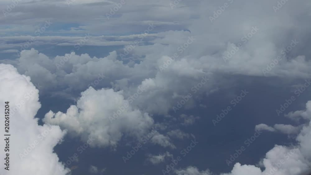 4K Traveling by air. Wonderful view of the sky and clouds from above, as seen through an airplane window. Plane in flight trip and beautiful views from the perspective of the traveler in the cabin-Dan 4K Traveling by air. Wonderful view of the sky and clouds from above, as seen through an airplane window. Plane in flight trip and beautiful views from the perspective of the traveler in the cabin-Dan
