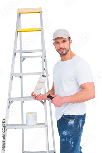 handyman with paint roller and ladder