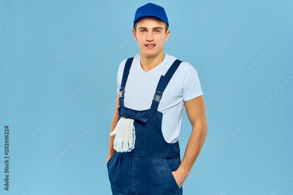 man in overalls gloves in his pocket man in overalls gloves in his pocket