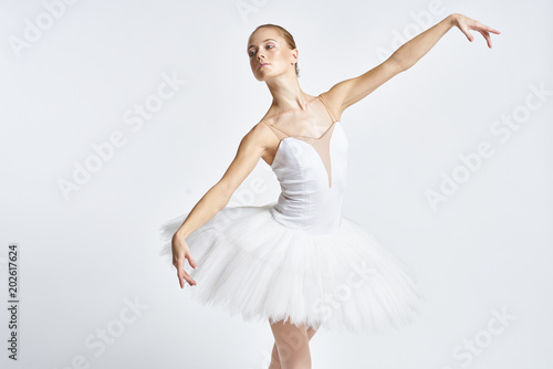 Ballerina in a light bathing suit and in a white tutu