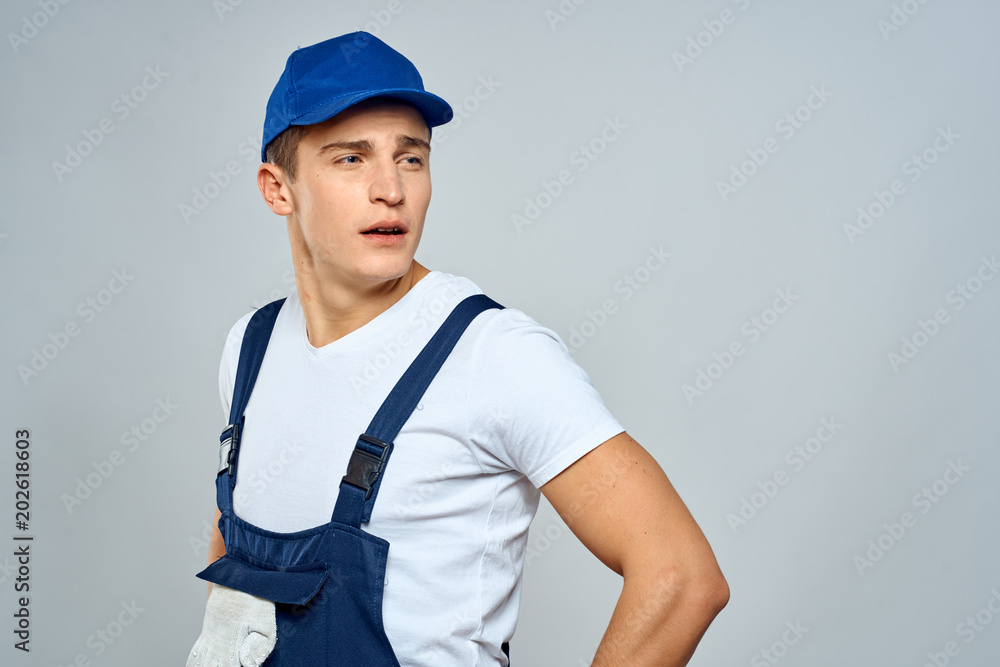 career in a blue cap and jumpsuit looks to the side career in a blue cap and jumpsuit looks to the side