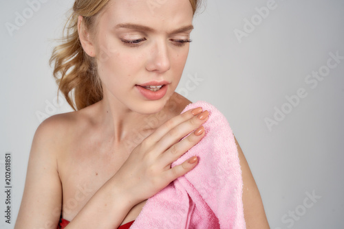 woman holding a pink towel in her hand