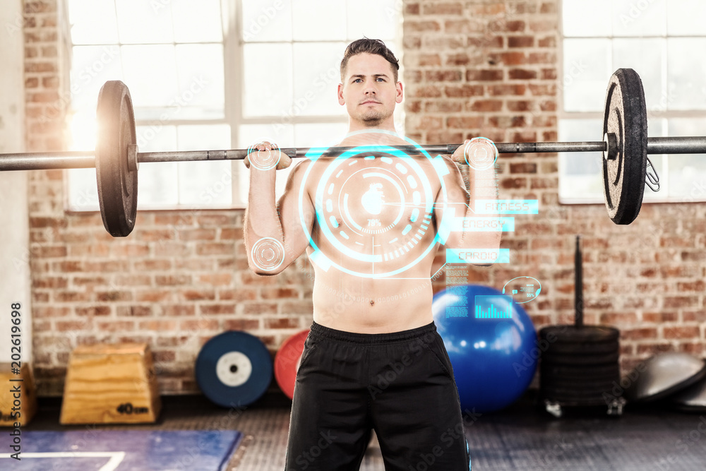 Muscular serious man doing weightlifting against fitness interface Muscular serious man doing weightlifting against fitness interface
