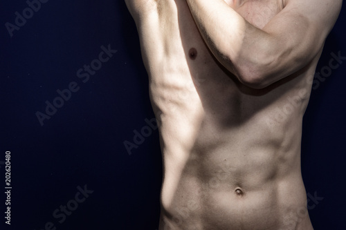 Anatomy of the male body. Attractive man. Blue background. 