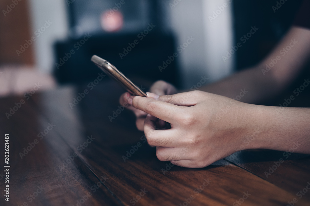 Young lady hands' using mobile phone. Selective focus. Copy space at the left. Young lady hands' using mobile phone. Selective focus. Copy space at the left.