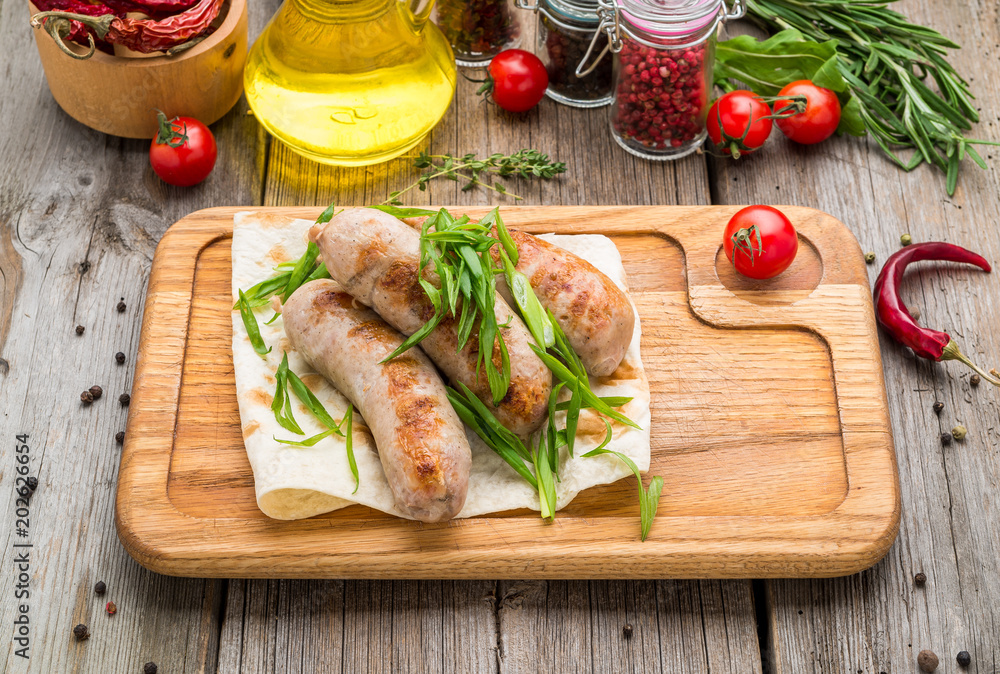 grilled sausages on the grill on the board grilled sausages on the grill on the board