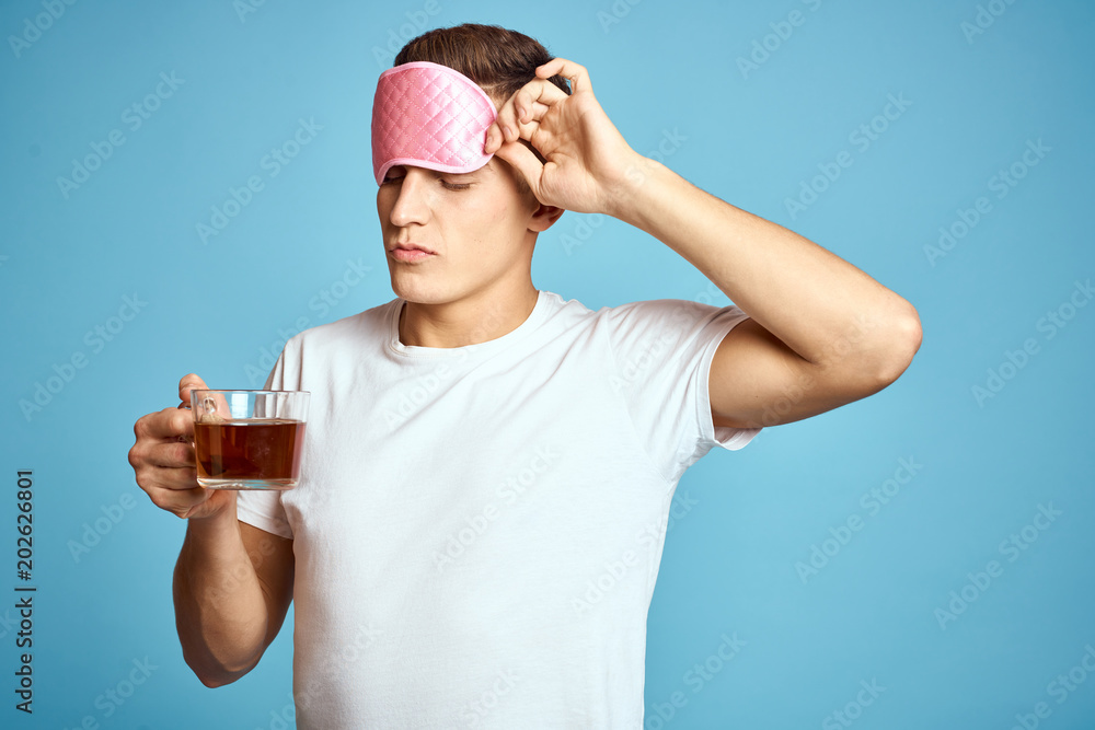 young man drinking a glass of water isolated on white young man drinking a glass of water isolated on white