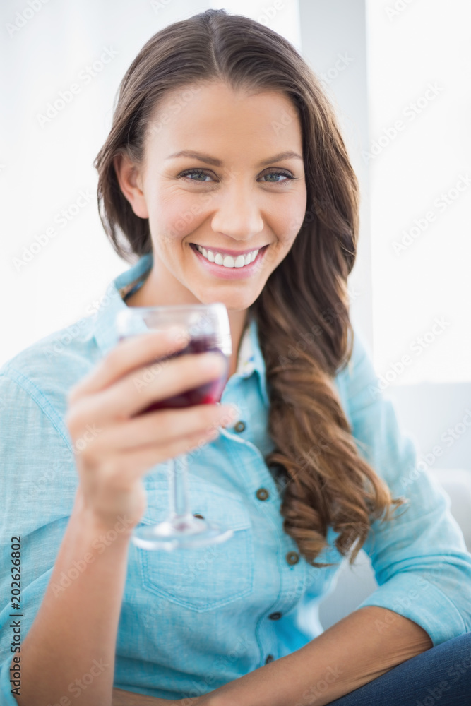 Cheerful gorgeous brunette holding glass of red wine Cheerful gorgeous brunette holding glass of red wine
