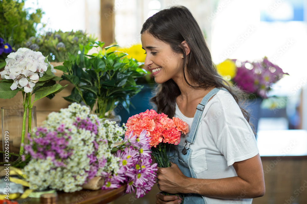 Woman selecting flowers at florist shop