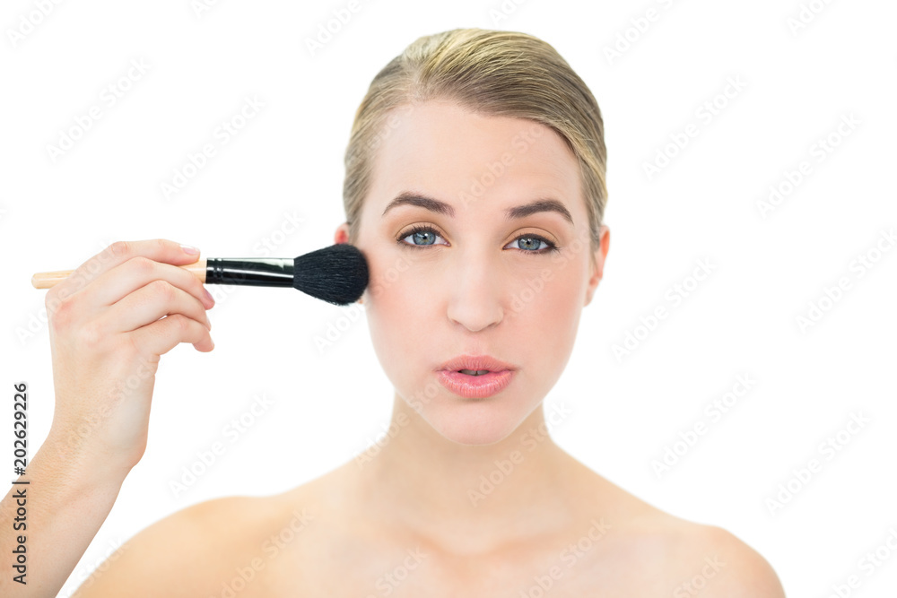 Content attractive blonde using blusher brush Content attractive blonde using blusher brush