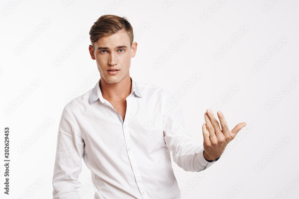 young man in shirt gesticulates with his hand young man in shirt gesticulates with his hand