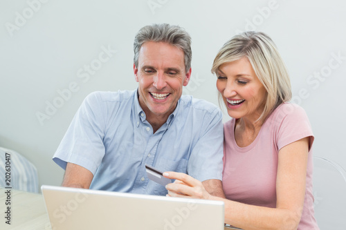 Cheerful couple doing online shopping at home © WavebreakmediaMicro