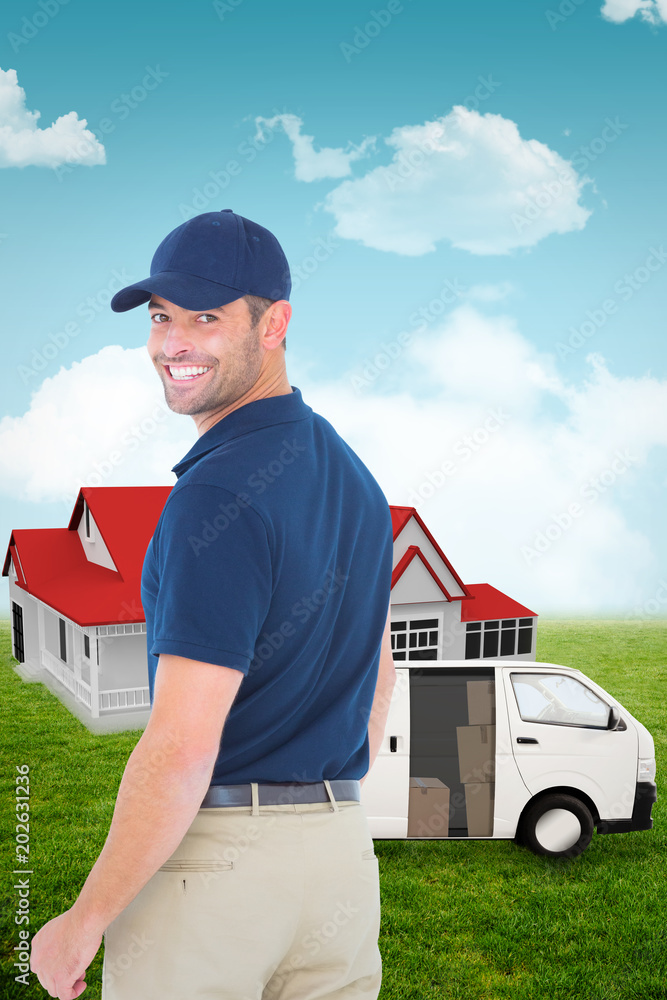 Happy delivery man wearing baseball cap against blue sky Happy delivery man wearing baseball cap against blue sky