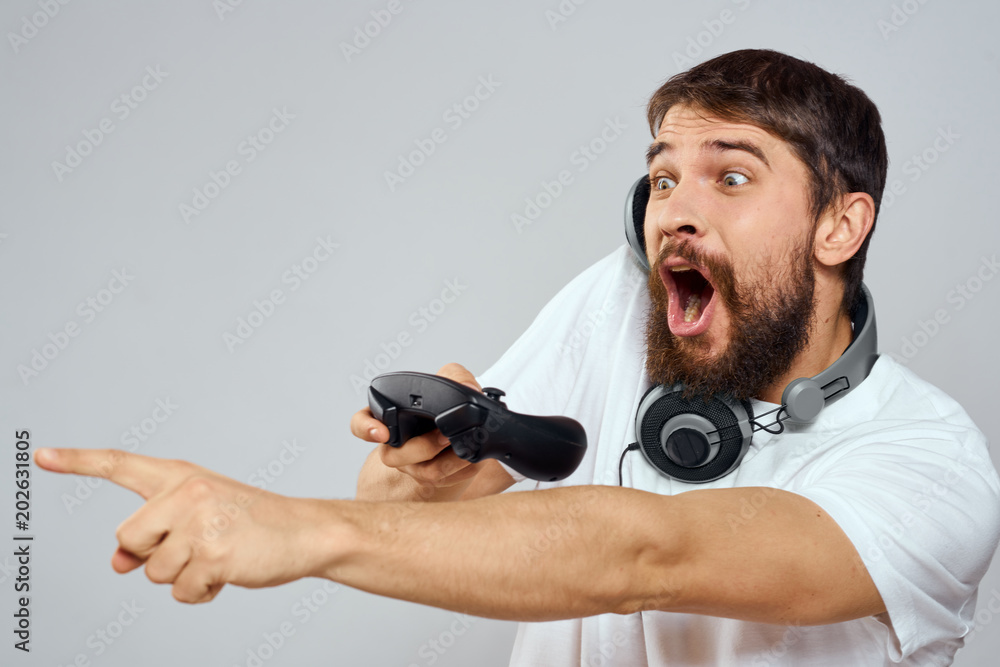 emotional man with a joystick and headphones around his neck emotional man with a joystick and headphones around his neck