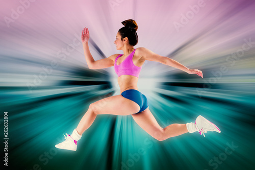 Fototapeta Naklejka Na Ścianę i Meble -  Fit brunette running and jumping against abstract background