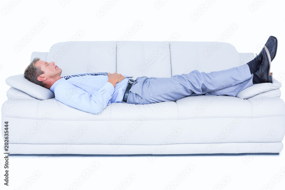 Tired businessman lying on the sofa Tired businessman lying on the sofa