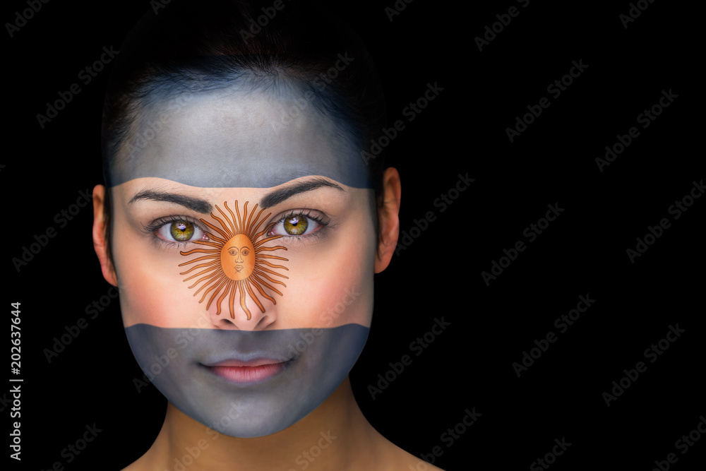 Φωτογραφία Composite image of argentina football fan in face paint against black