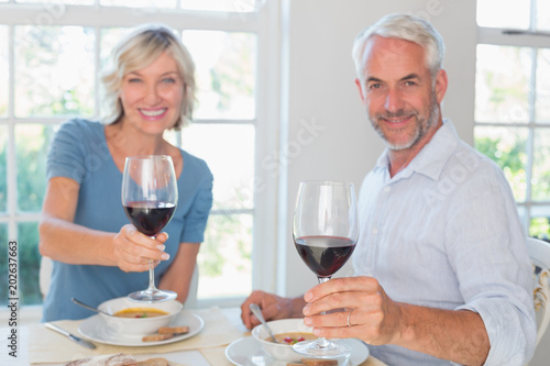 Mature couple with wine glasses and food © WavebreakmediaMicro