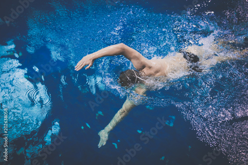 Male swimmer at the swimming pool. Underwater photo. Male swimmer. © lenets_tan