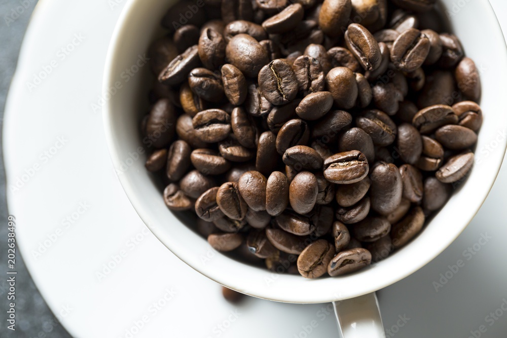 Cup with whole coffee beans